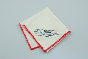 Image: A seal on ice, one of a set of 3 embroidered napkins, each with unique scene